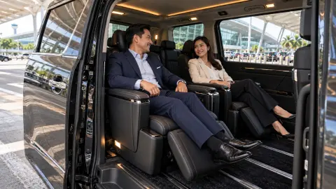 Corporate delegates boarding a private van outside a Johor Bahru hotel